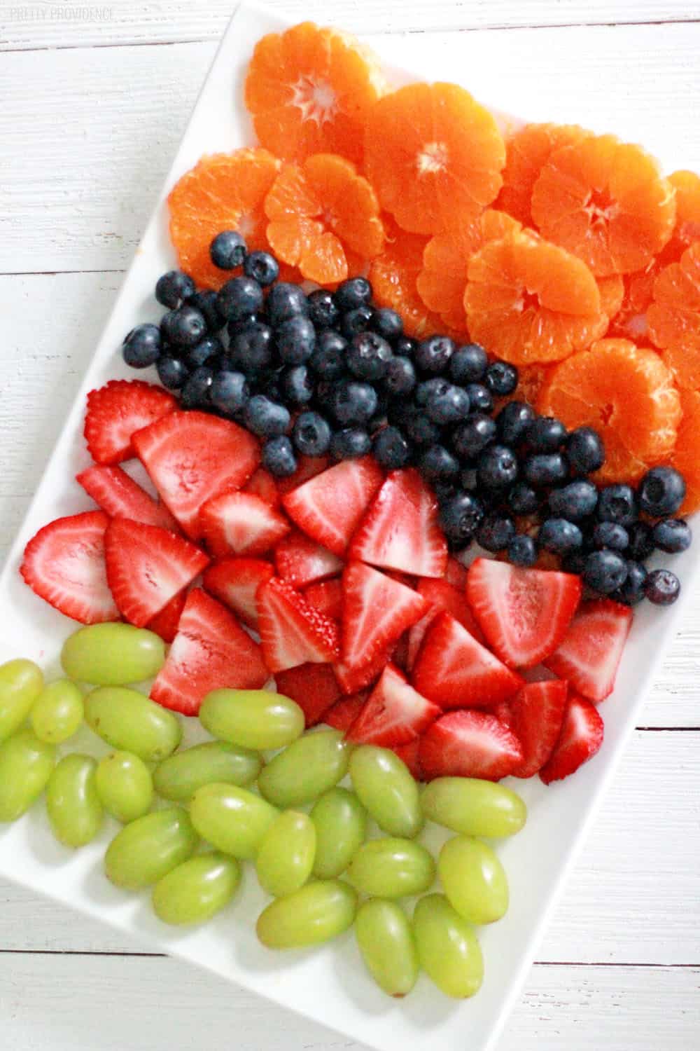 Colorful fruit salad - strawberries, blueberries, green grapes and oranges!