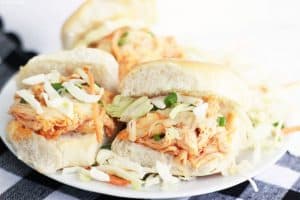 These easy buffalo chicken sliders with coleslaw and green onions.