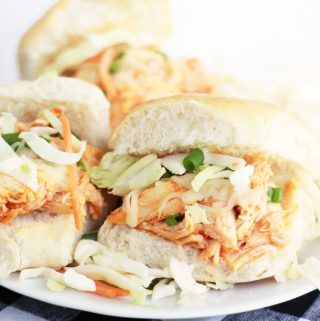 These easy buffalo chicken sliders with coleslaw and green onions.