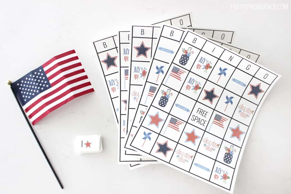 Fourth of July bingo cards fanned out next to a small American flag.