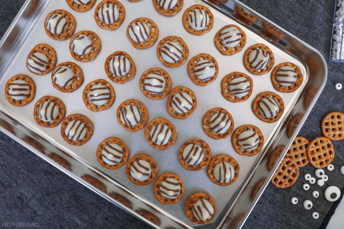 pretzel hugs with eyes for halloween on a white table with a black runner