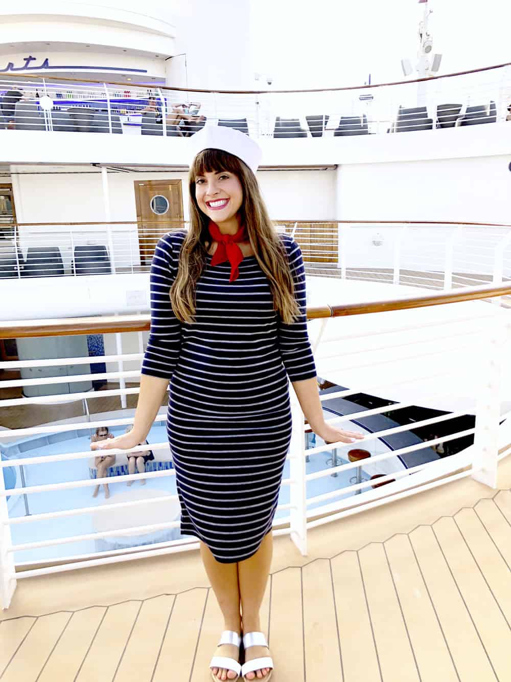 a girl in a sailor costume standing on a deck of a ship