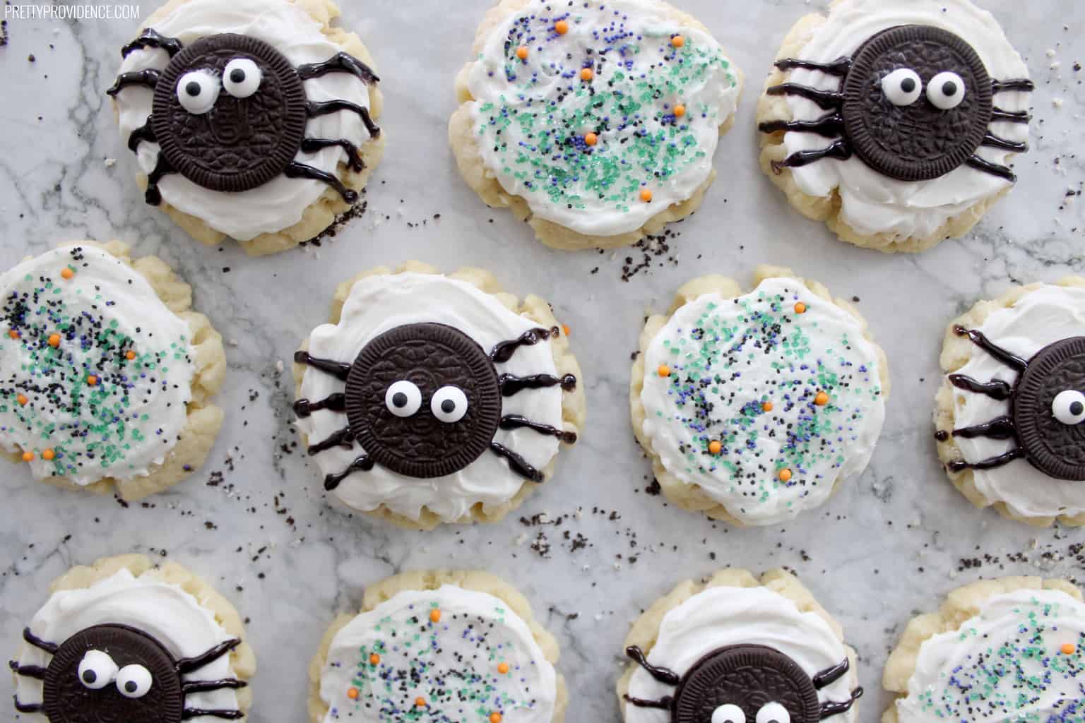 halloween sugar cookies on a granite counter top, some with oreo spiders