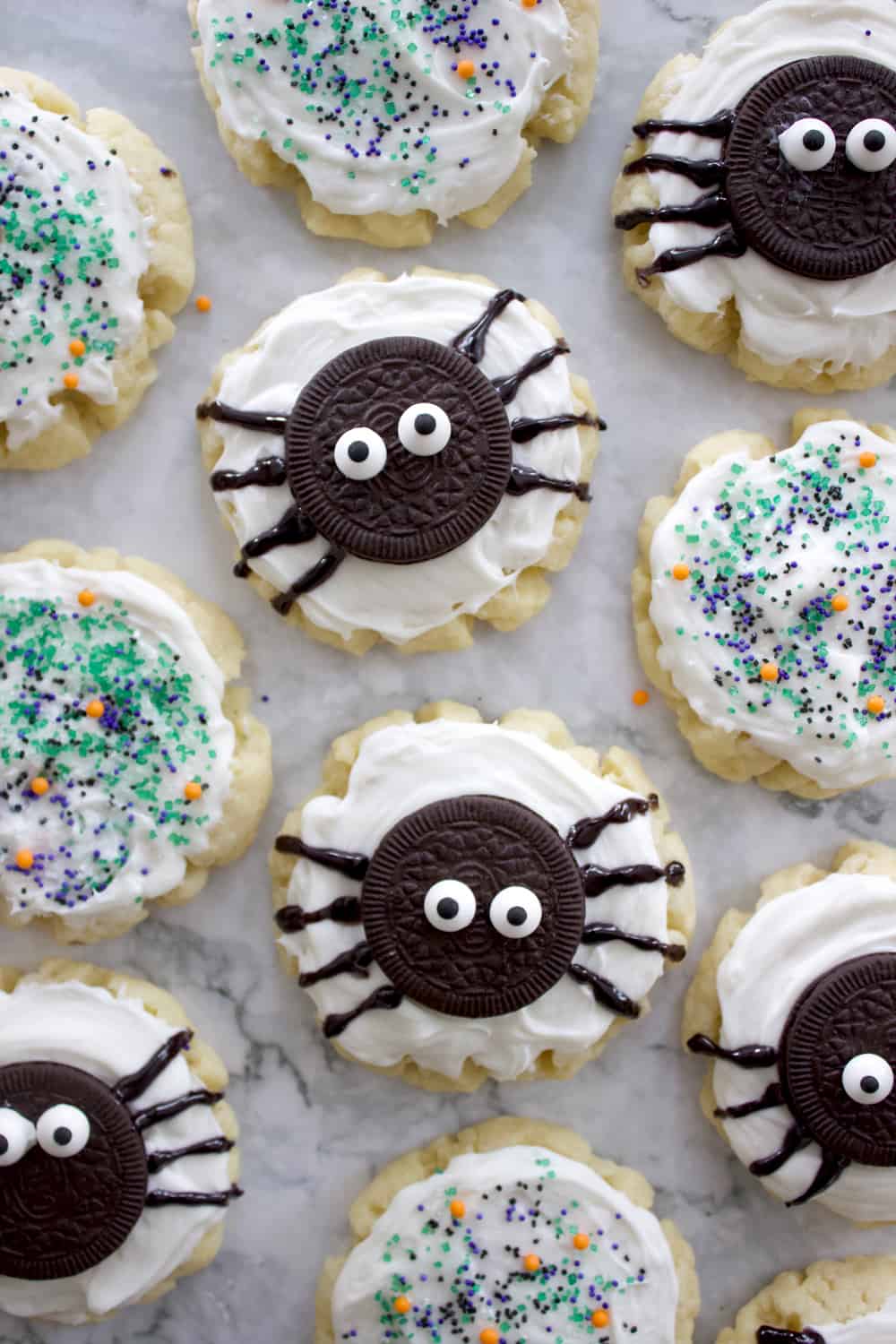 halloween sugar cookies close together on a granite countertop