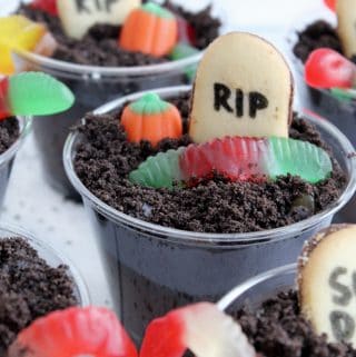 How dang cute are these easy Halloween Dirt Cups?! The grey layer has a secret ingredient that makes these taste BEYOND amazing!