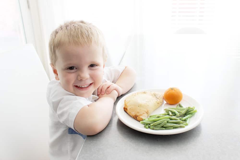 Little boy eating a Michael Angelo's calzone! 