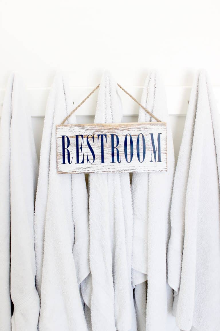 Cute diy restroom sign hanging on some towels.