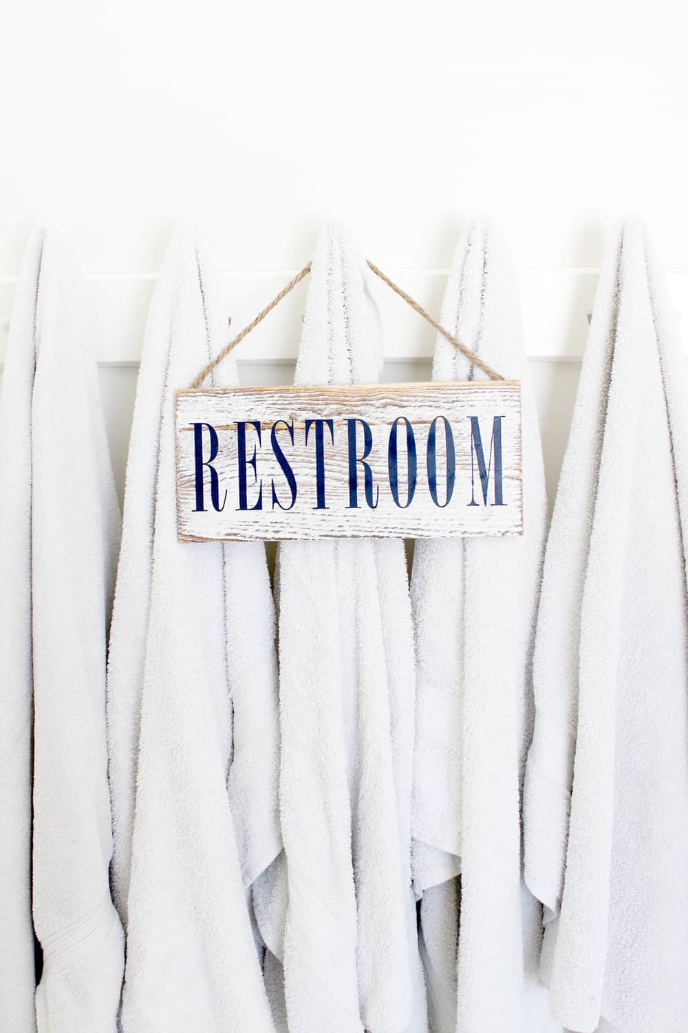 Cute diy restroom sign hanging on some towels. 