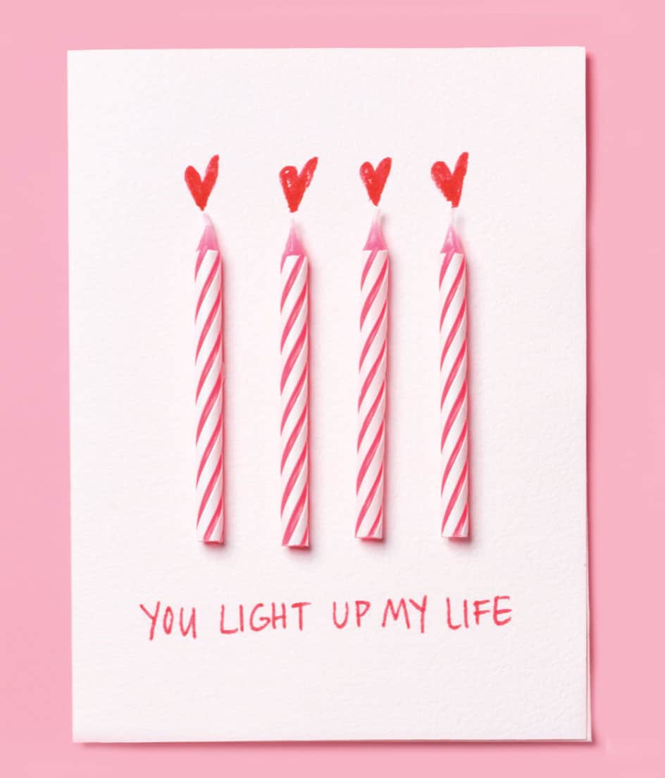 White Valentine's Day card with pink birthday candles on it and the phrase 'You light up my life' - from realsimple.com