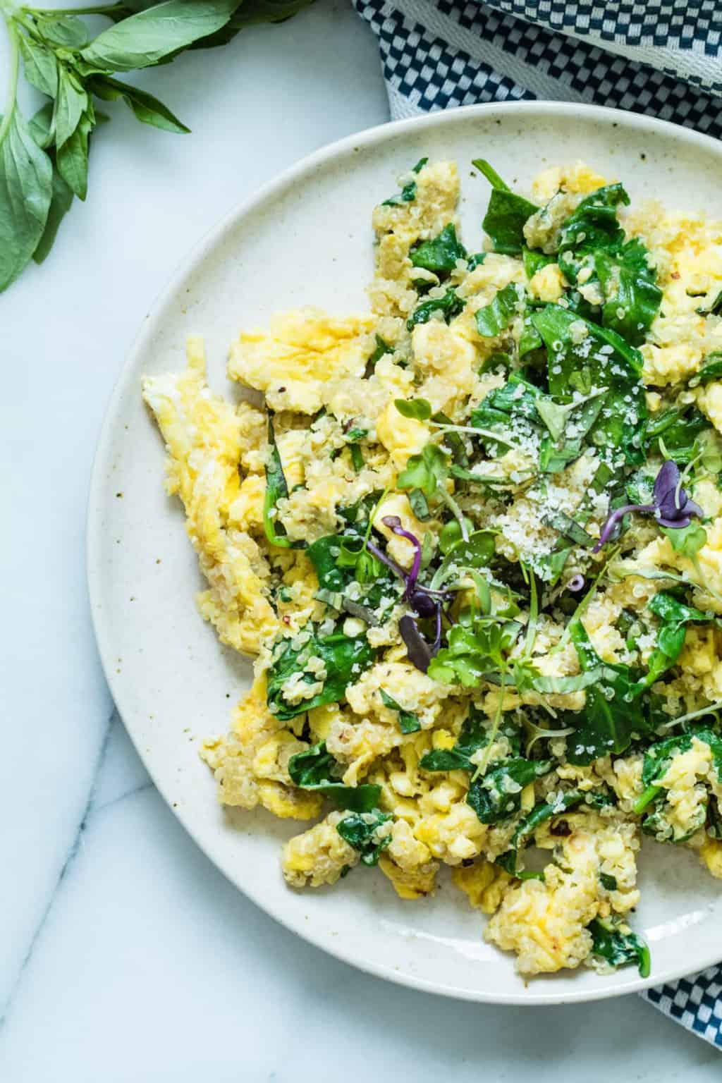 egg scramble on a granite countertop by fresh basil