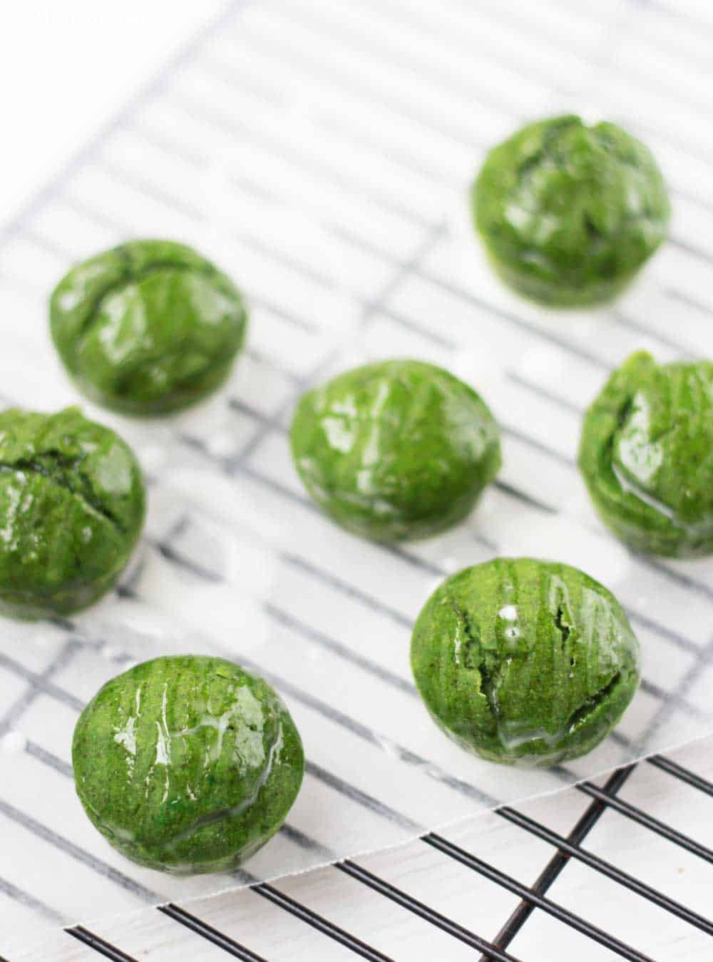 green monster muffins on a cooling rack with icing drizzled over