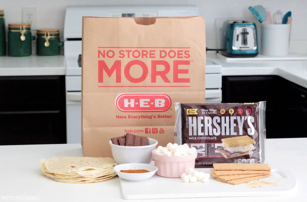 S'mores Quesadilla ingredients on kitchen counter, tortillas, marshmallows, Hershey's bars and graham crackers with an H-E-B paper grocery bag behind it.