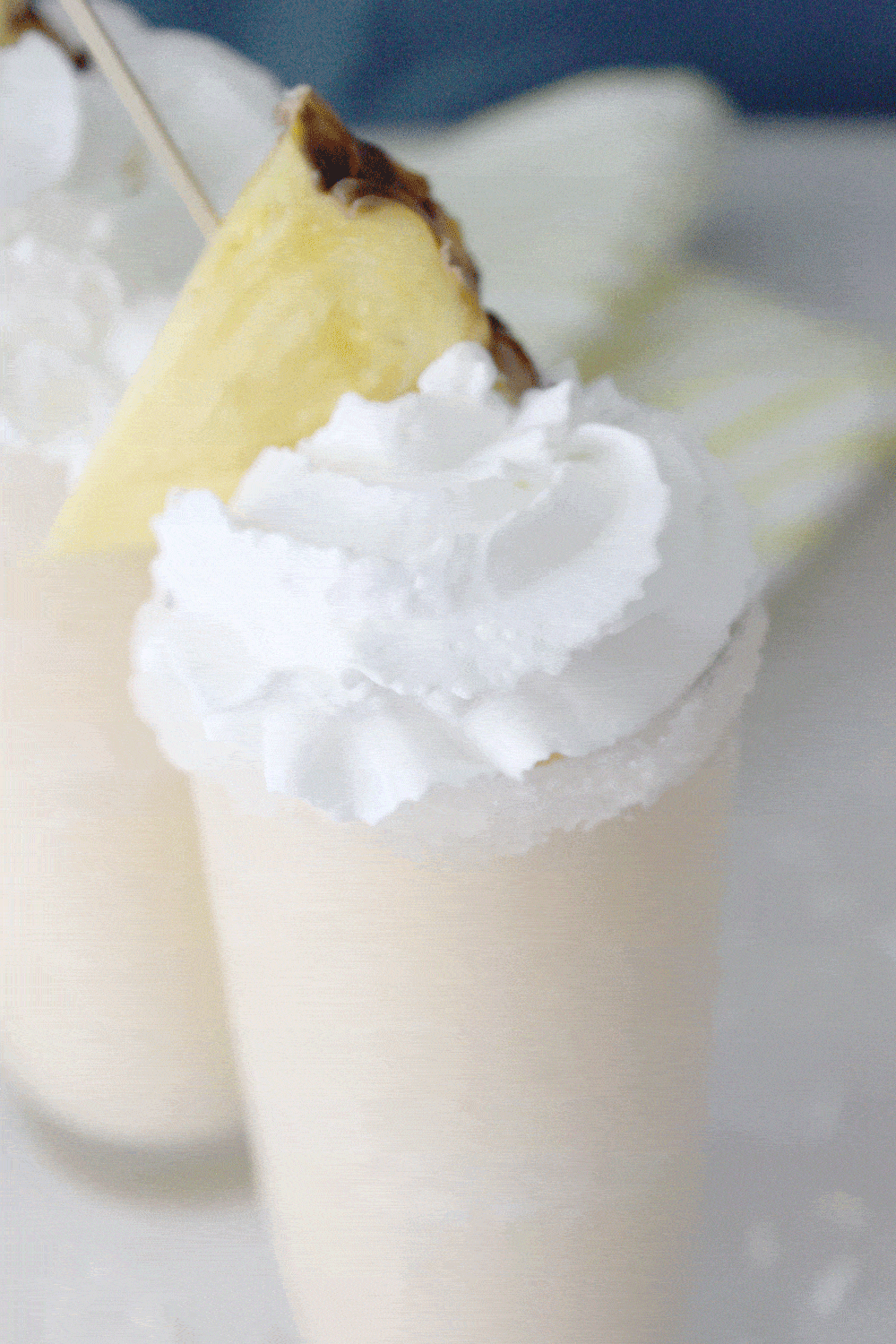 skinny pina colada slush topped with whip cream and pineapple 