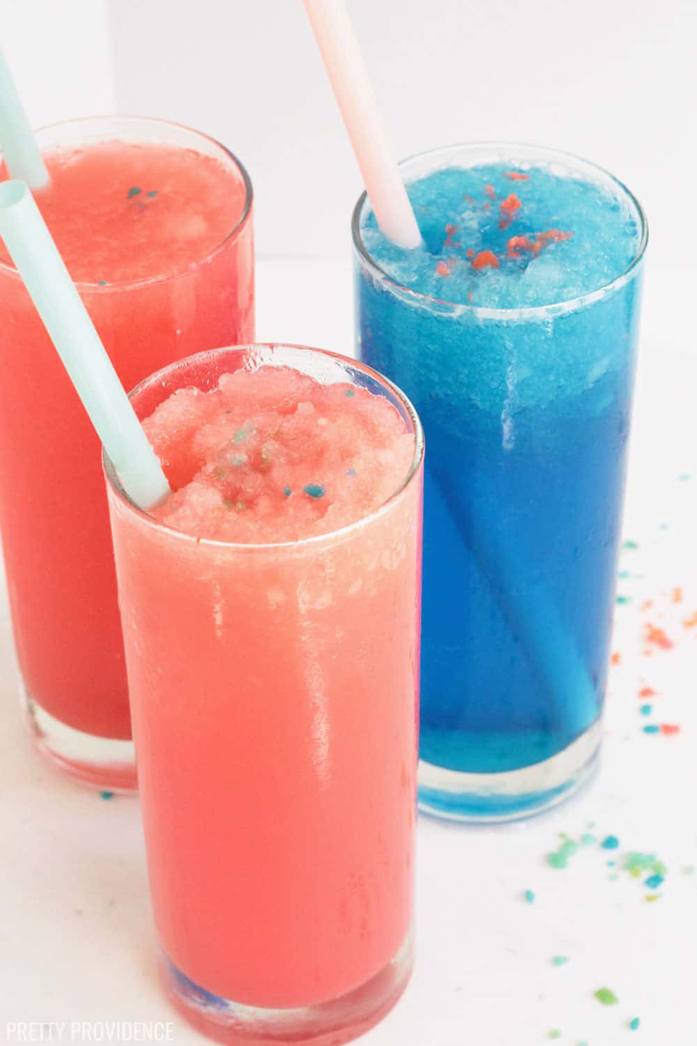 Pink, red and blue sonic slushies with pop rocks in tall glasses with straws.