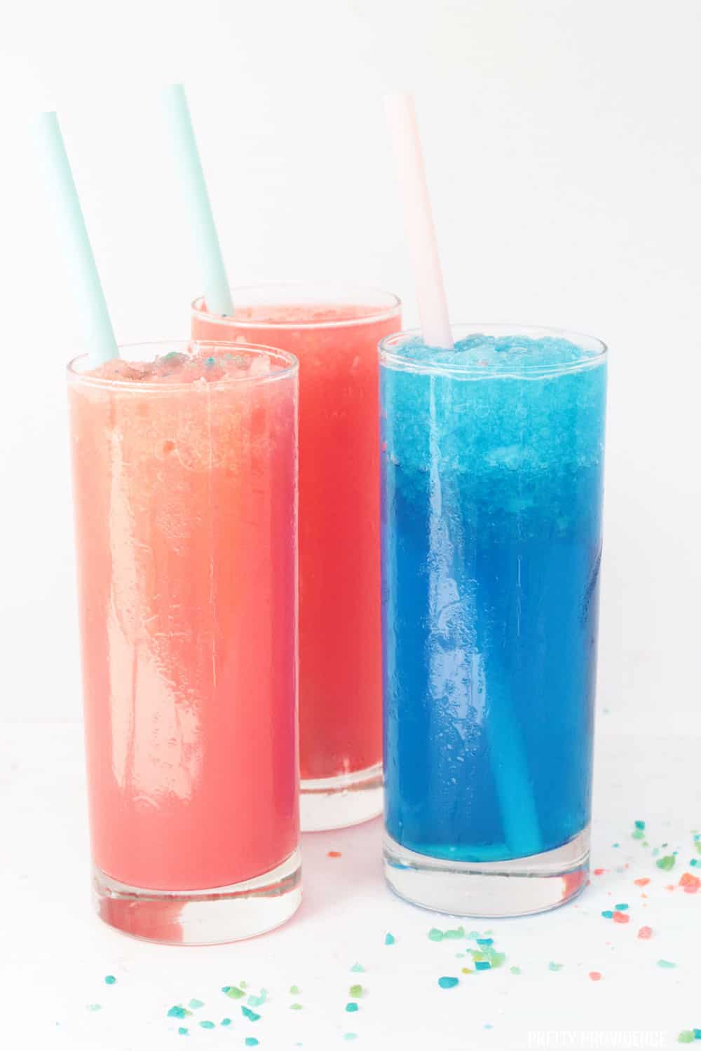 Sonic Slush Copycat Slushies - Pink, Red and Blue slushies in tall glasses with pop rocks on top.