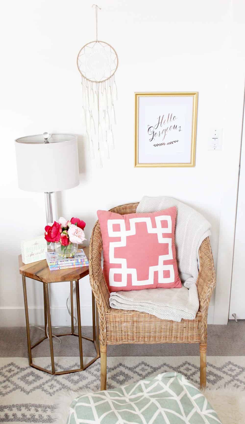 cute wicker chair and metal wood topped side table in a girls bedroom