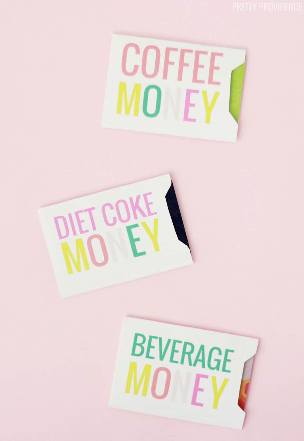 White gift card envelopes that say 'Diet Coke Money' 'Coffee Money' and 'Beverage Money' in colorful pink, green, yellow and coral letters, on a pink background.