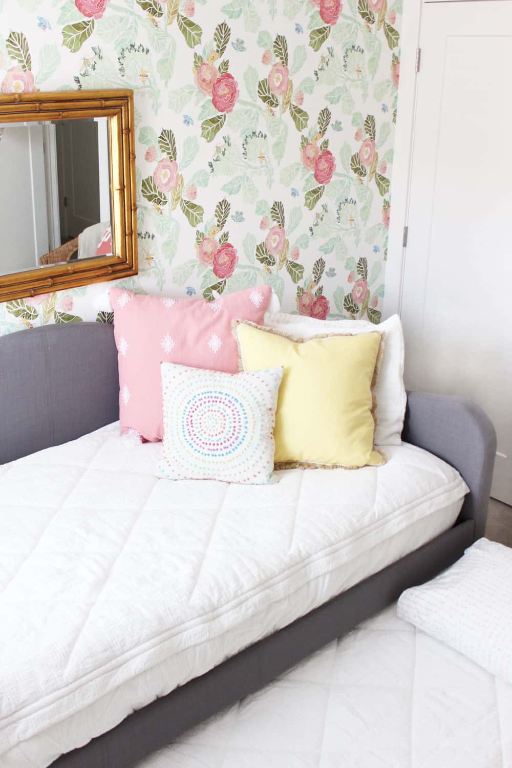 white bedding with colorful pillows