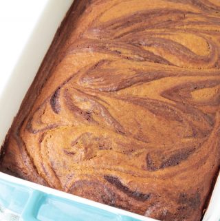Pumpkin Swirl Brownies baked to perfection in a blue baking dish.