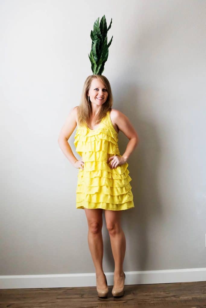 Pineapple Costume made from a yellow dress and faux plant headband on a woman.