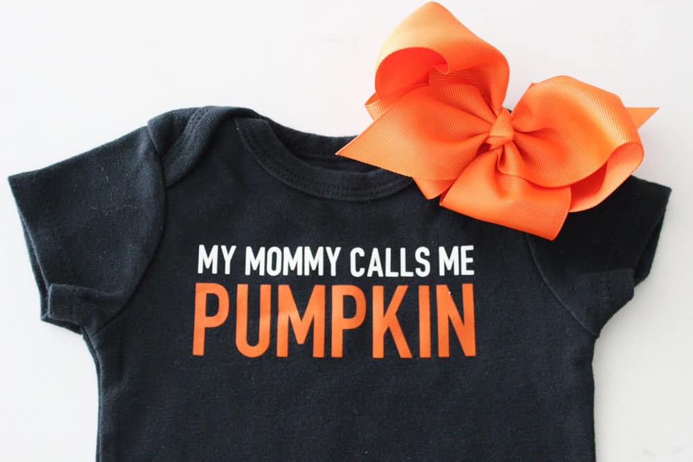 black onesie that says my mommy calls me pumpkin with an orange bow