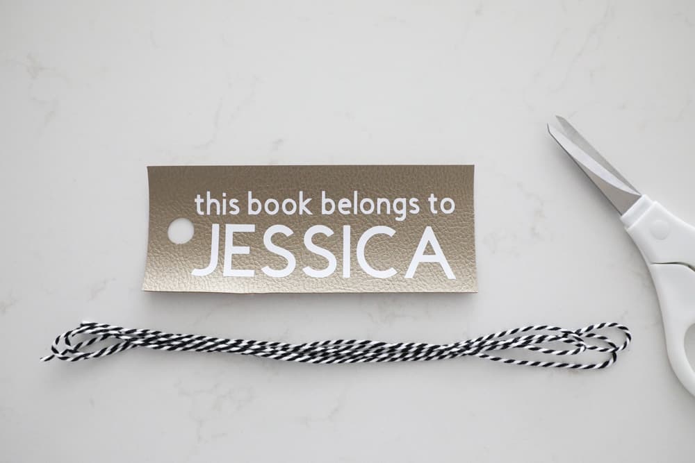 bookmark next to white scissors and black and white bakers twine