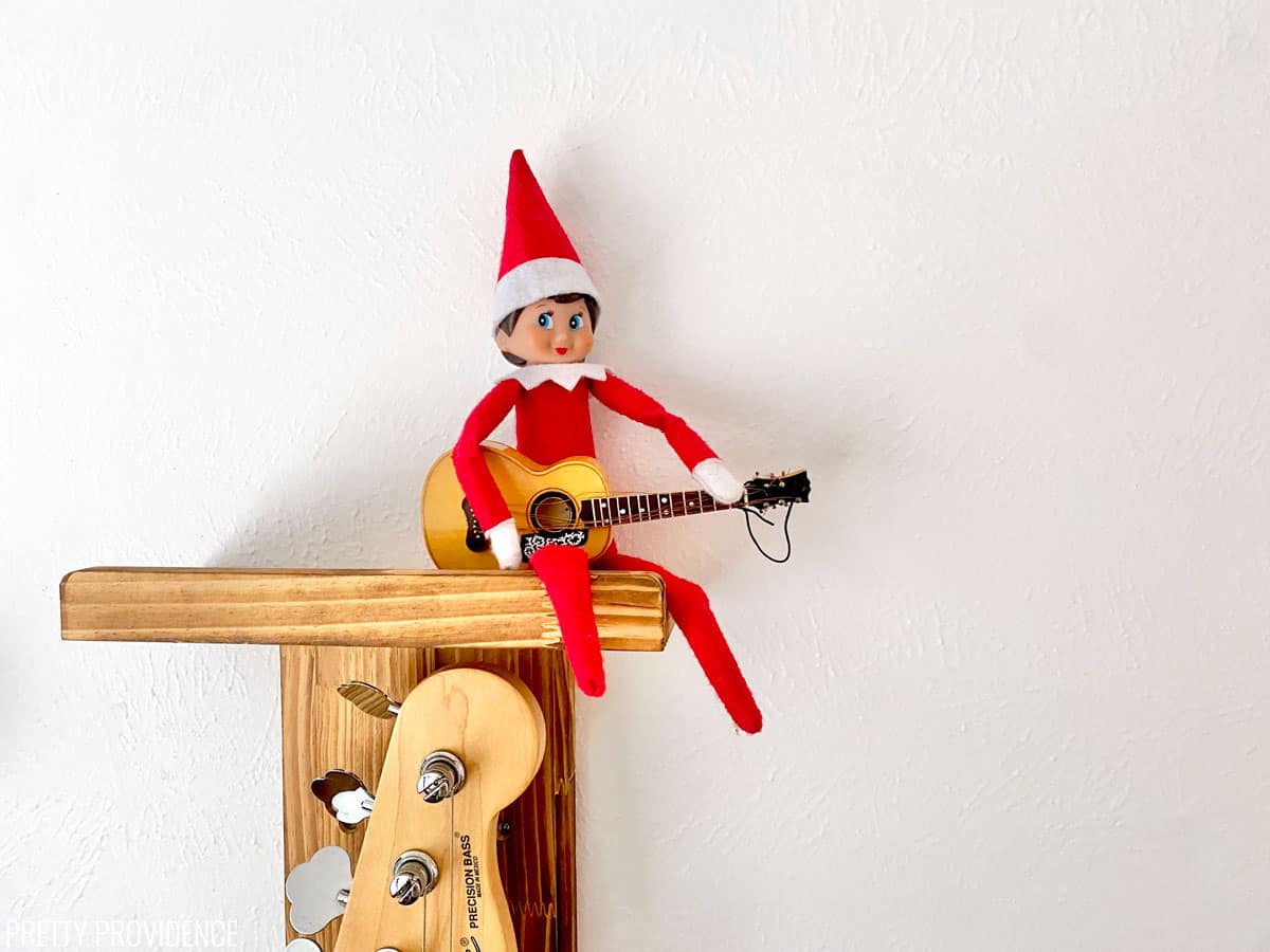 Elf on the Shelf with a guitar Christmas ornament.
