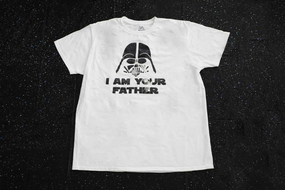 white "I am your father" shirt against a black background