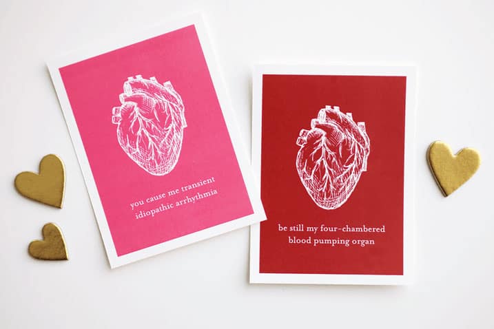 Human heart illustration in white on pink and red Valentines cards.