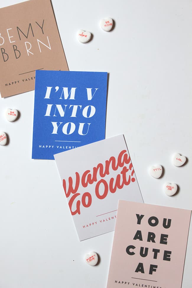 Four printable valentines with retro fonts that read "I'm v into you" "wanna go out?" "you are cute AF" and "Be My BB RN"