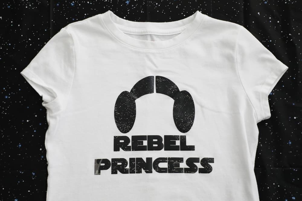 white t shirt that says "rebel princess" and has princess leia buns. 