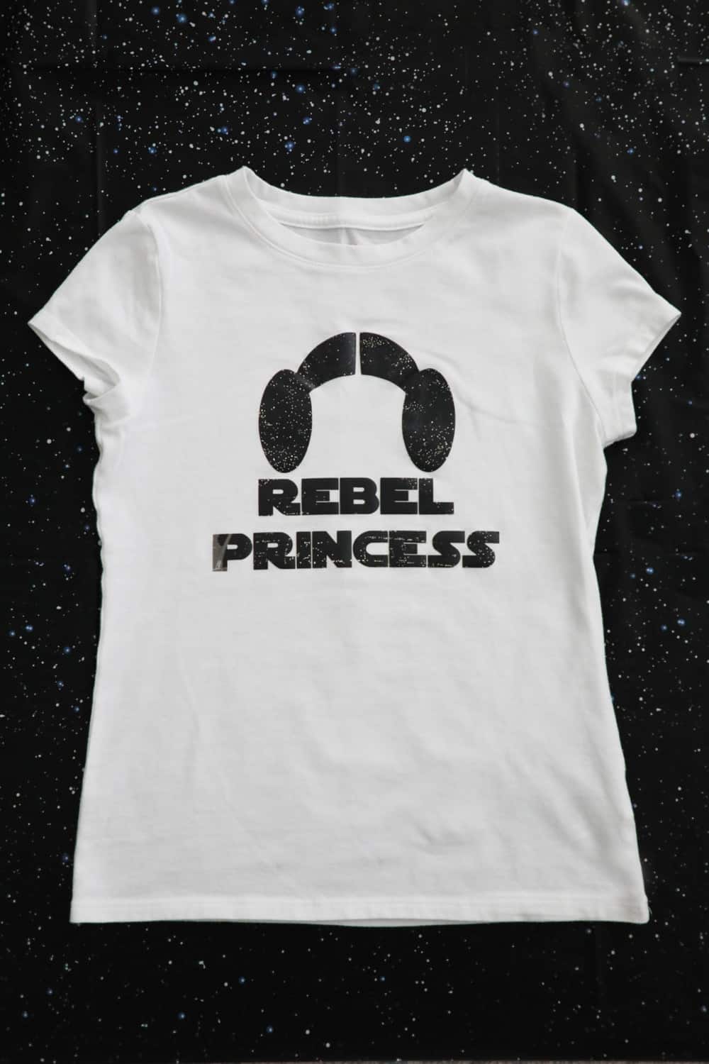 white t shirt that says "rebel princess" and has princess leia buns. 