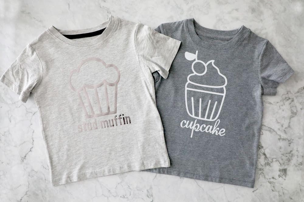 two grey t shirts next to each other, one says "stud muffin" one says "cupcake" 