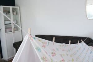 How to make a fort with clothes line or rope, clothes pins, and bed sheets.