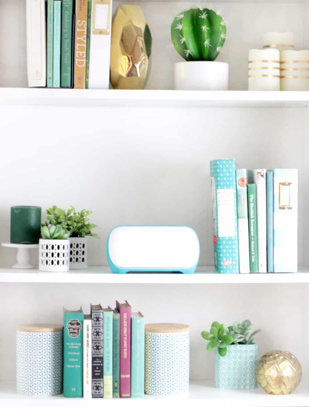 cute styled bookshelf with plants, books, and cricut joy