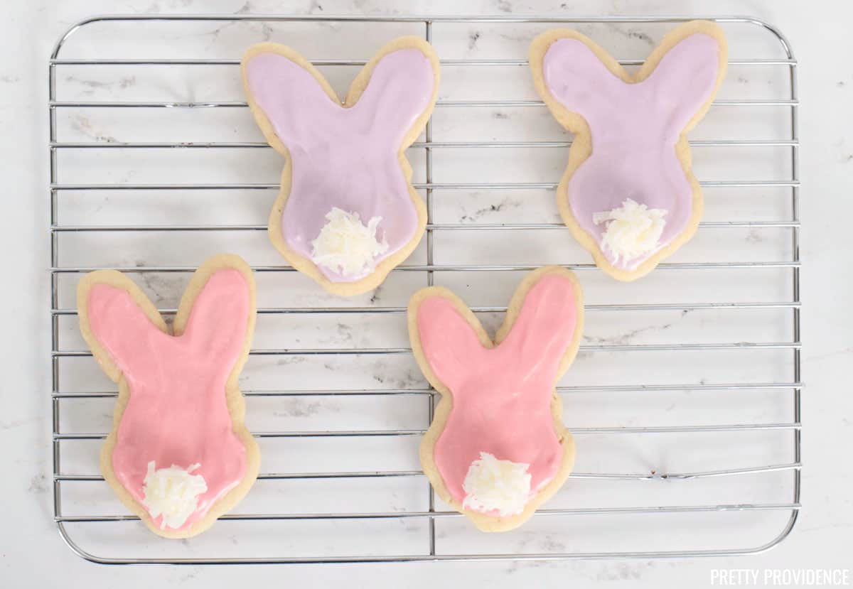 Pink and purple bunny shaped Sugar cookies with marshmallow coconut tails.