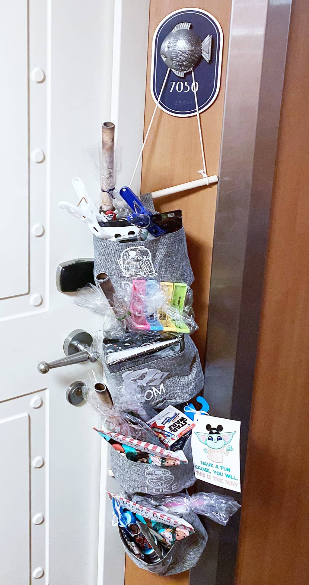 a fish extender stuffed with gifts and prizes outside a stateroom door