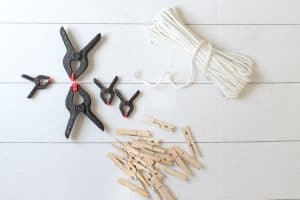 Clamps, clothes pins and rope on a white background.