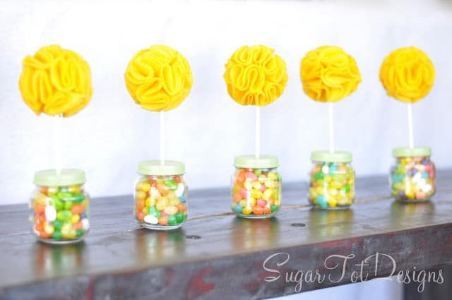 Topiaries with jelly beans in little baby food jars with yellow felt flowers