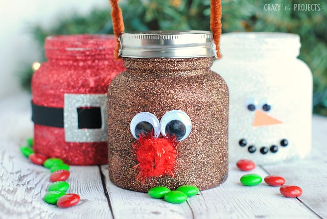 Christmas treat jars decorated to look like rudolph, snowman and santa.