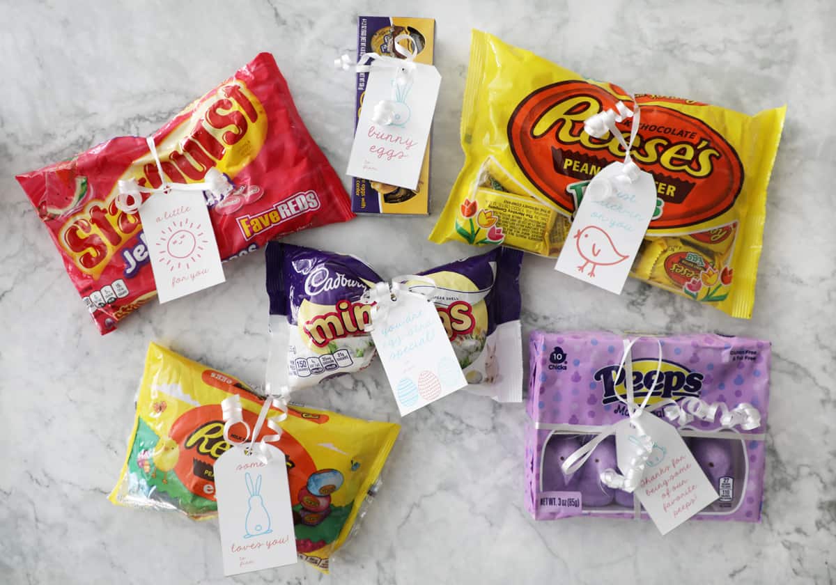 six bags of Easter candy with free printable gift tags attached