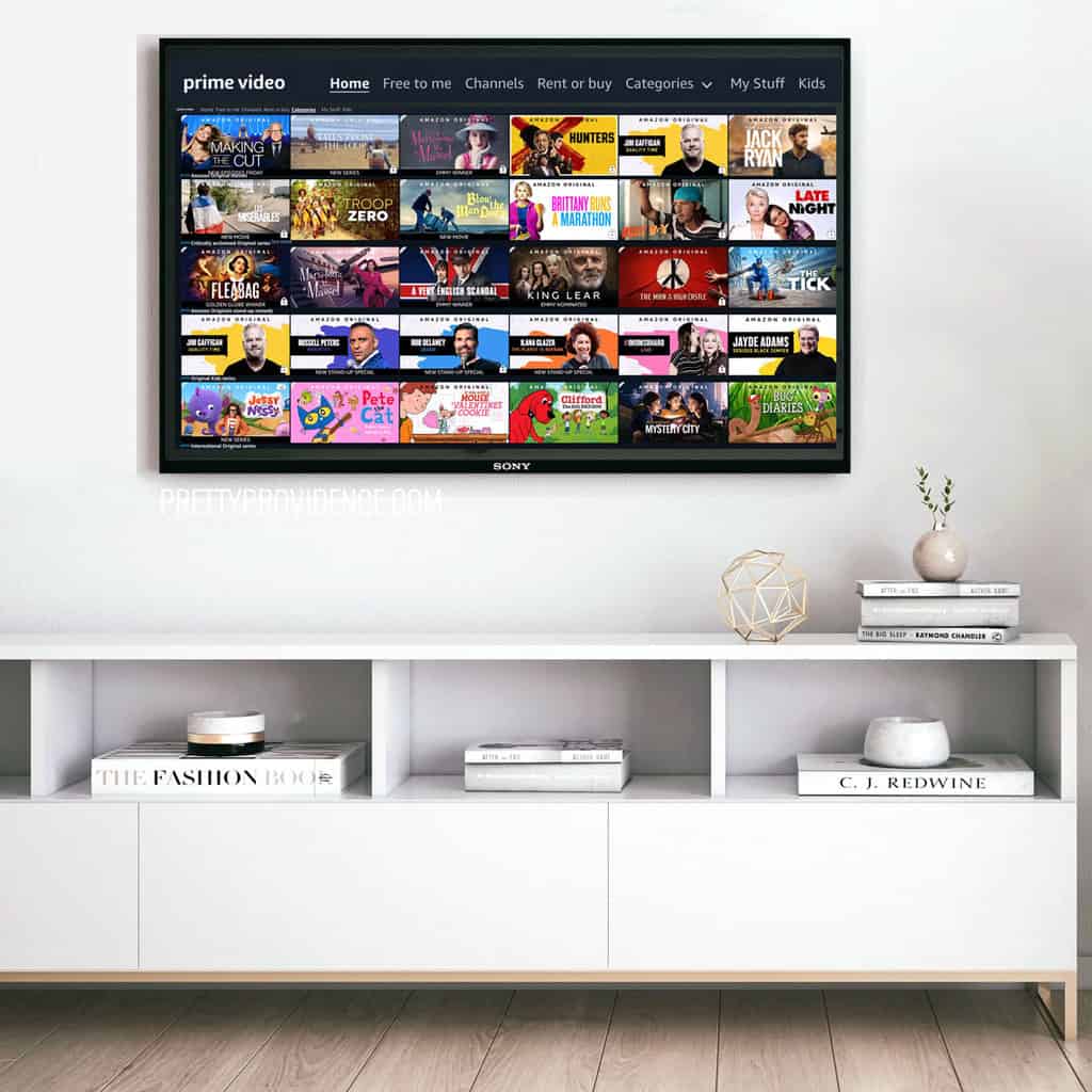 Amazon Prime TV menu on a flat screen TV above a white media console
