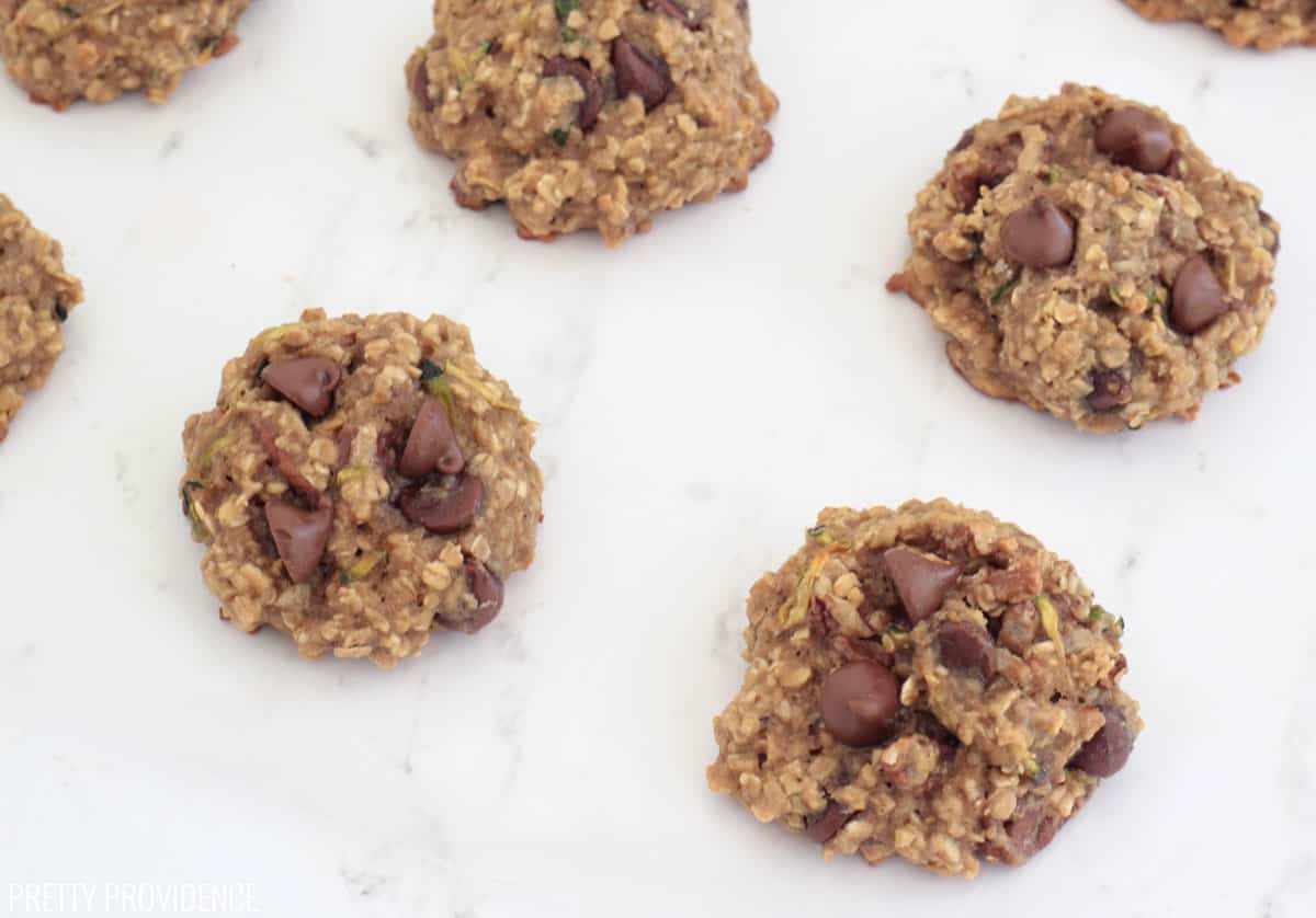 Oatmeal breakfast cookies with chocolate chips on a marble counter top.