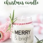 DIY Christmas candle in baby food jar with sprig of green and red baker's twine and a label that reads 'merry and bright'