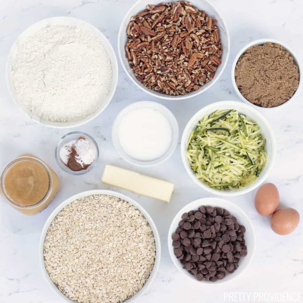 Cookie ingredients in small bowls on a marble surface.