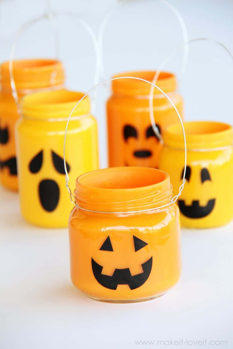 Baby food jars painted to look like pumpkins and jack-o-lanterns for halloween decoration.