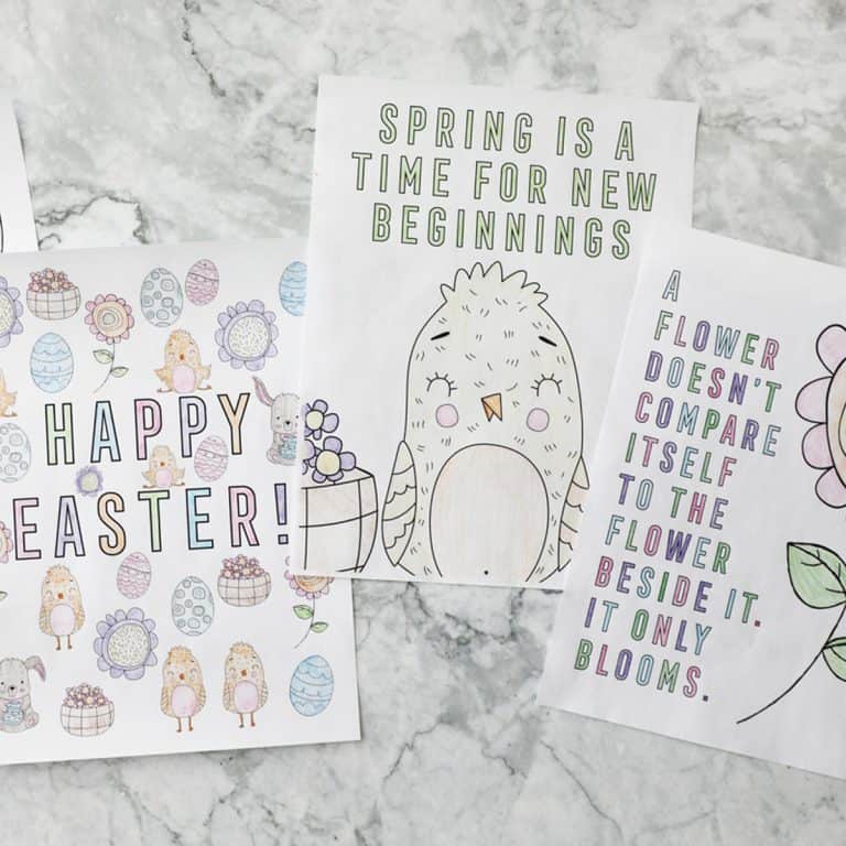 three colored spring coloring pages on a white marble countertop