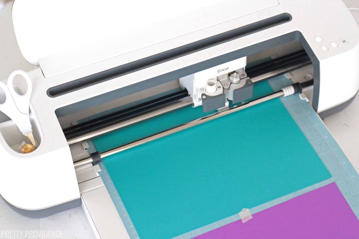 Cricut maker cutting teal and purple card stock