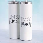 Two white tumblers with viny decals that say 'I'm so fancy'