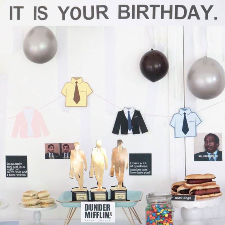 The Office birthday party table with decorations, food, balloons and "it is your birthday" sign
